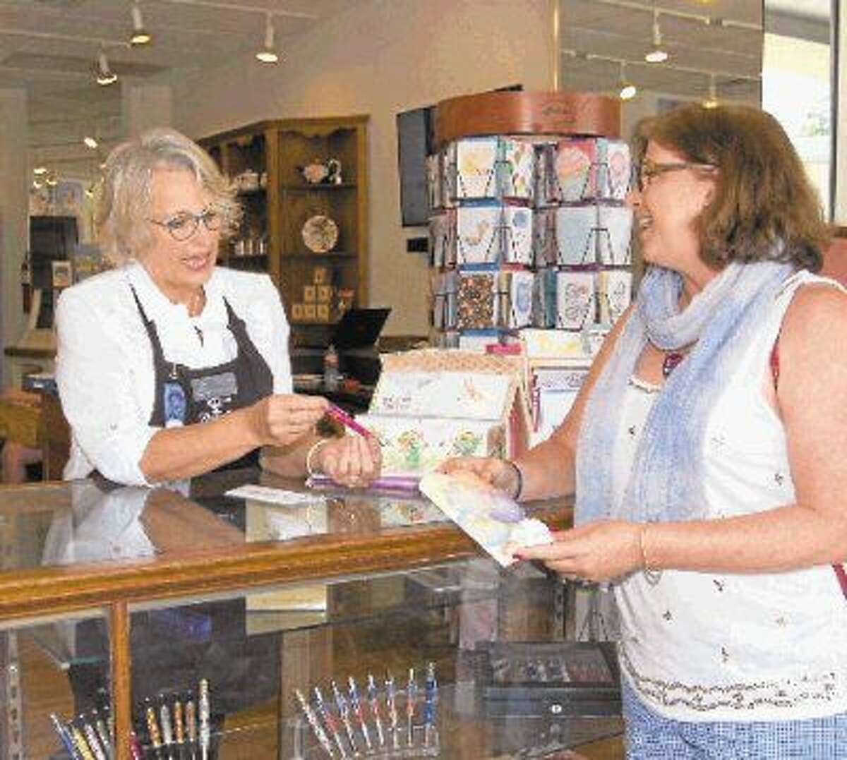 Jill Stacy of Houston, right, chooses a hand-crafted pen gift with the assistance of Cyndy Oller, volunteer store coordinator and New Danville board member.