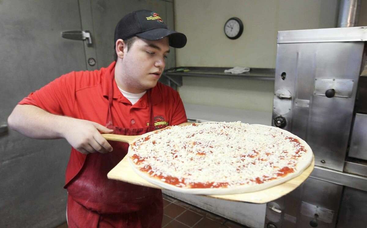 Noah Lira, 16, is a part of the third generation to participate in the Bekiri ‘s Brothers Pizza chain in Houston. He is the son of Sterling Ridge Brothers Pizza Express owners Jesse and Lima Lira and grandson to Zima and Haki Bekiri who helped start the chain in 1980.