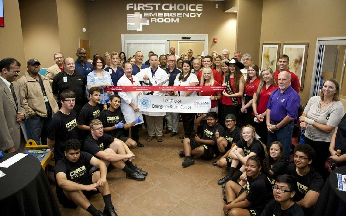 First Choice Emergency Room staff, Conroe Chamber of Commerce and the Conroe High School band gather to celebrate the emergency room’s Conroe location opening.