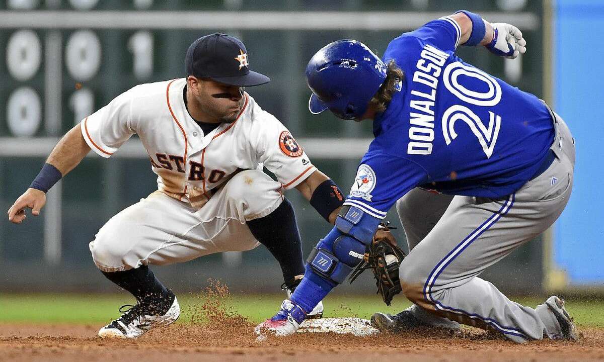 Houston Astros second baseman Jose Altuve tags out Toronto Blue Jays' Josh Donaldson on Tuesday in Houston.