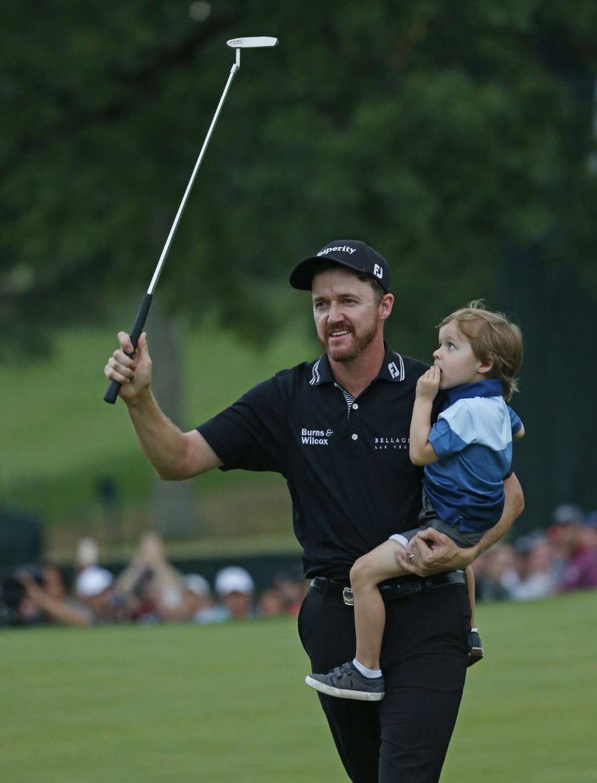Jimmy Walker celebrates with his son Beckett after winning the PGA Championship golf tournament at Baltusrol Golf Club in Springfield, N.J., Sunday, July 31, 2016.
