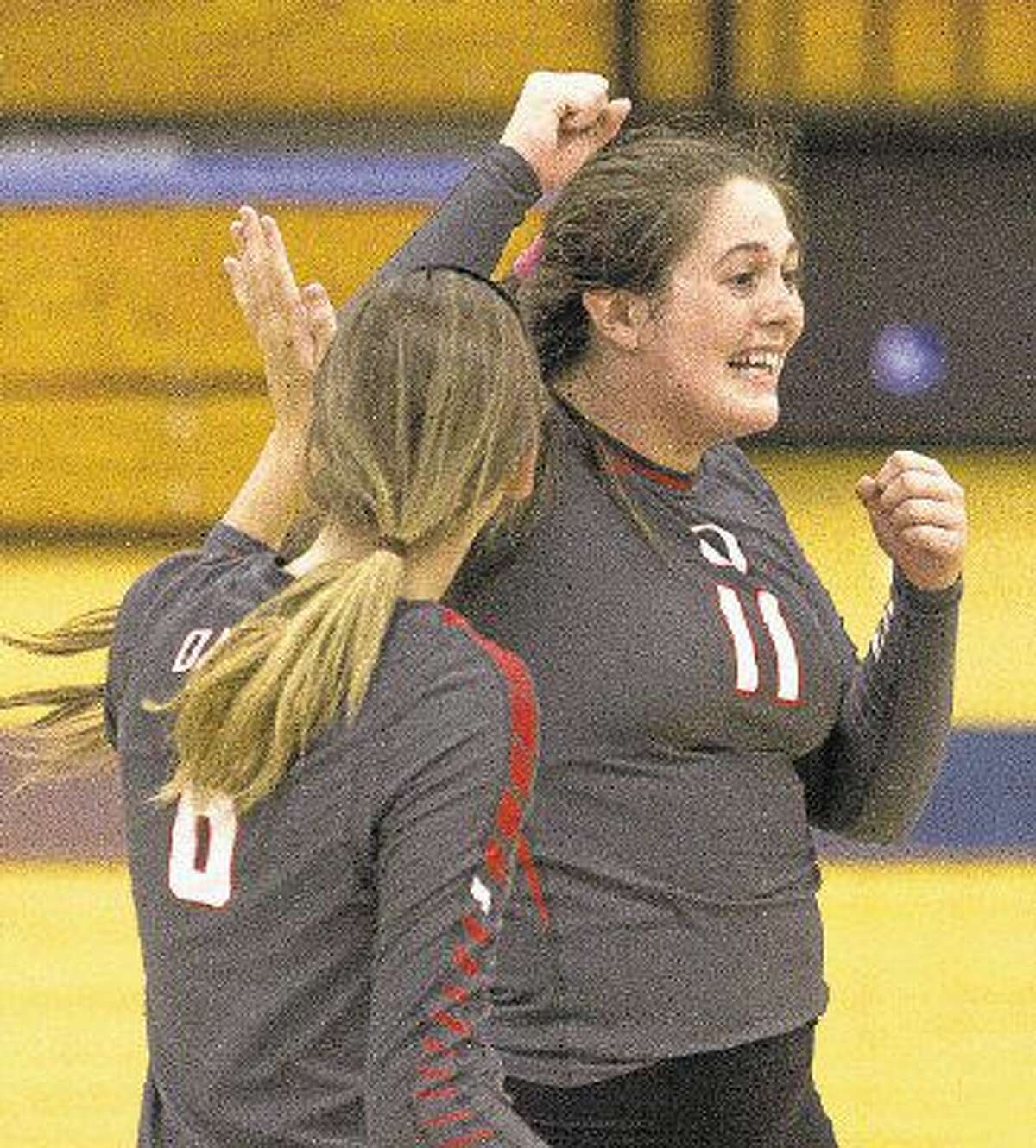 Oak Ridge's Carly Graham and Molly Russell celebrate a point in the third set of the gold bracket championship volleyball match during the Katy/Cy-Fair Nike Invitational. Go to HCNpics.com to purchase this photo and others like it.