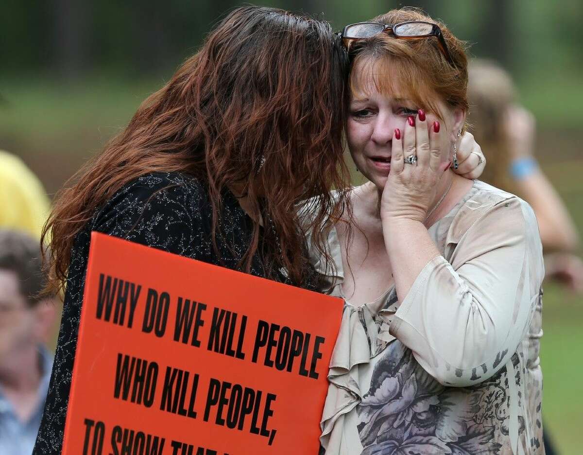 Dawn Skorcik, left, of Marietta, Ga., and Dawn Barber, of Powder Springs, Ga., comfort each other while protesting outside of Georgia Diagnostic Prison in Jackson, Ga., Tuesday evening before the execution of Kelly Gissendaner.