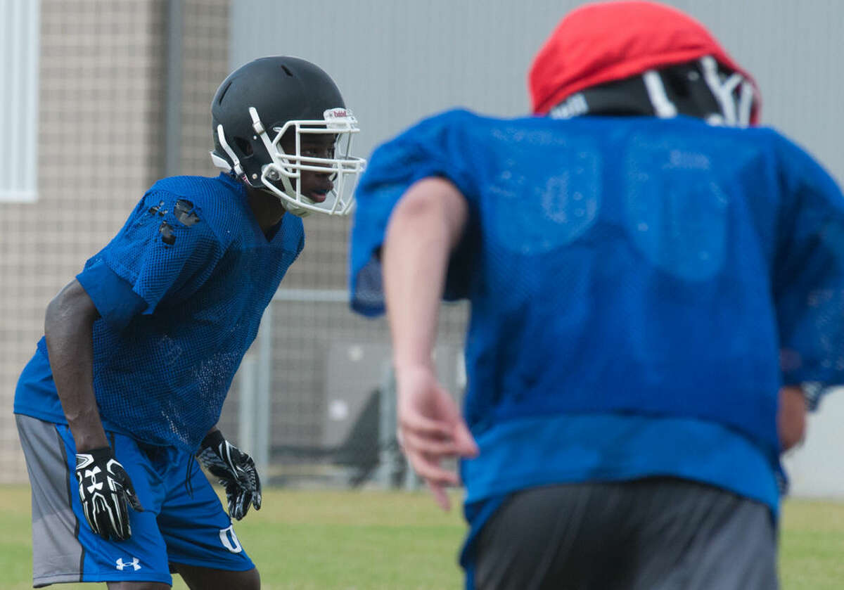 A New Caney cornerback reacts to the offense during a practice earlier this month at New Caney High School.