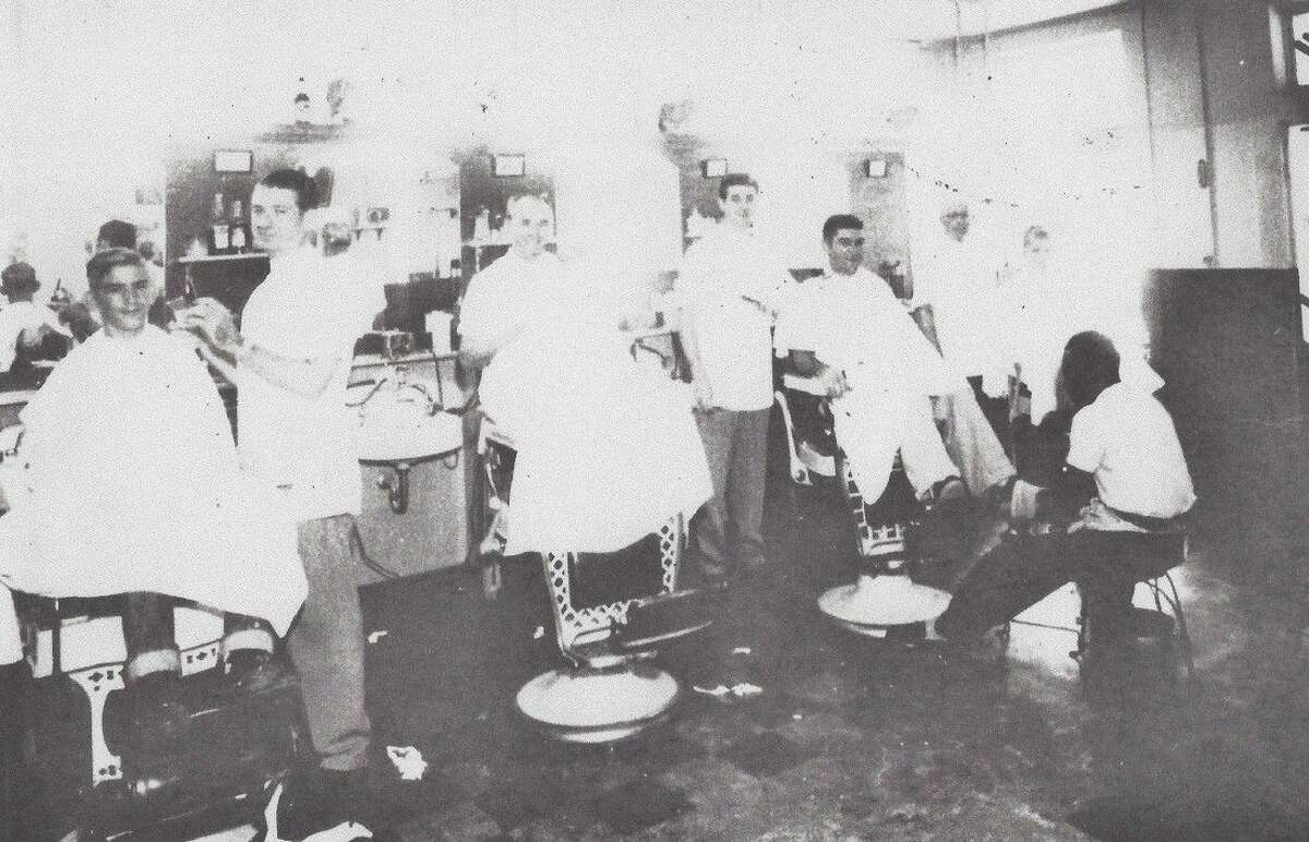 Pictured from left, barbers Stovall Thomas, Dalton Hearn, Bob Shepard and Sam Brannon with shoe shine man Jesse Mayers. The photo was taken about 1960 when Stovall Thomas owned the barber shop.
