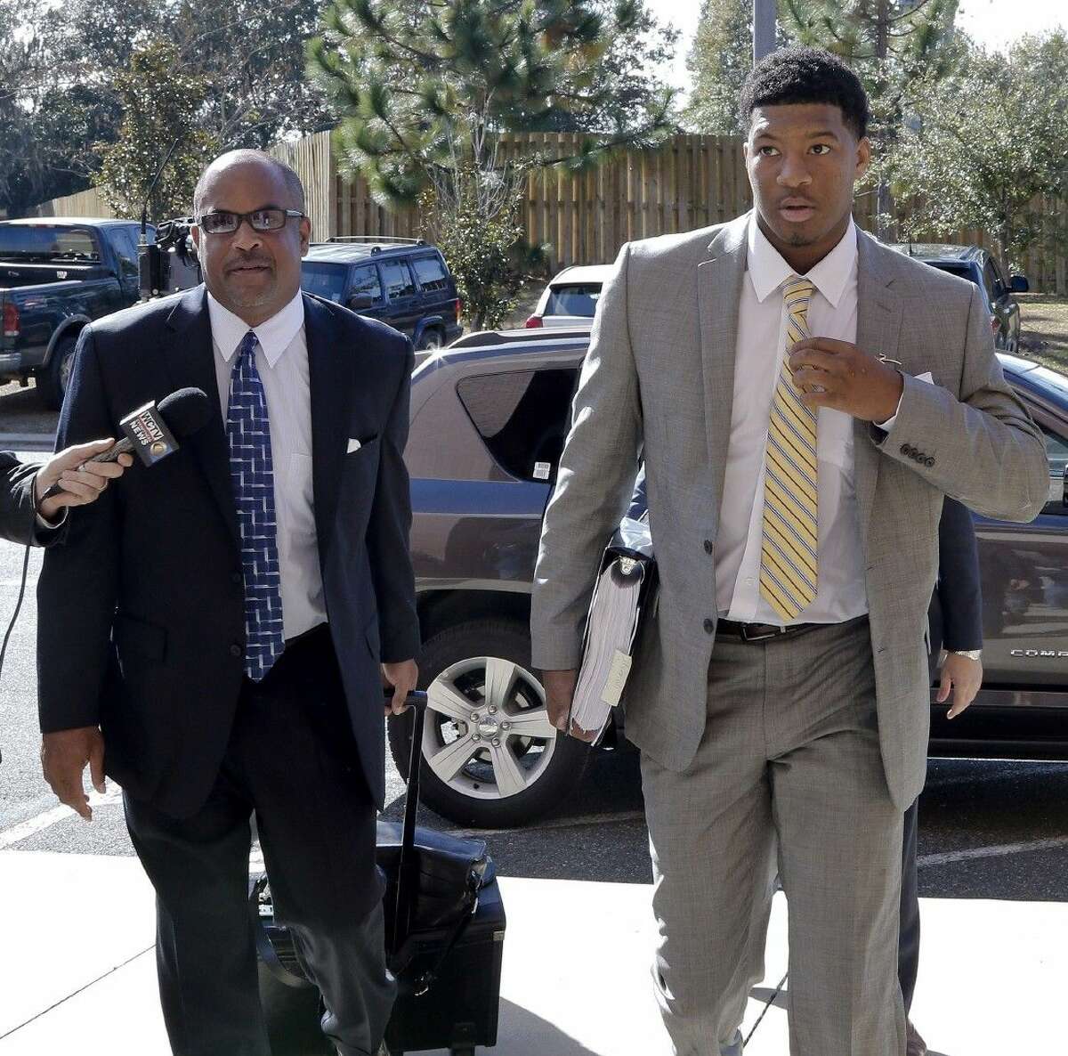 Florida State quarterback Jameis Winston, right, and his attorney David Cornwell arrive at Florida State's Materials Research building for his student code on conduct hearing.
