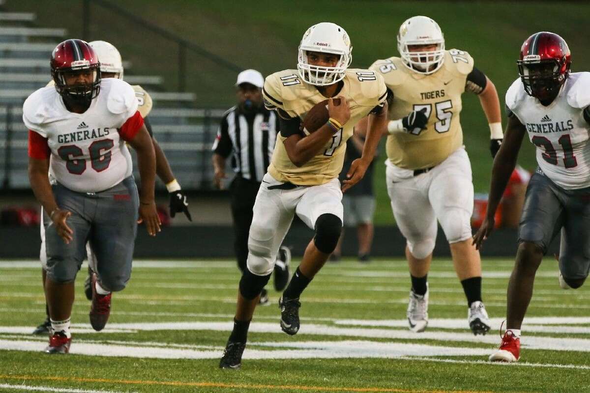 Conroe's Colby Kizzie (11) runs the ball during the high school football game against Aldine MacArthur on Friday at Moorhead Stadium.