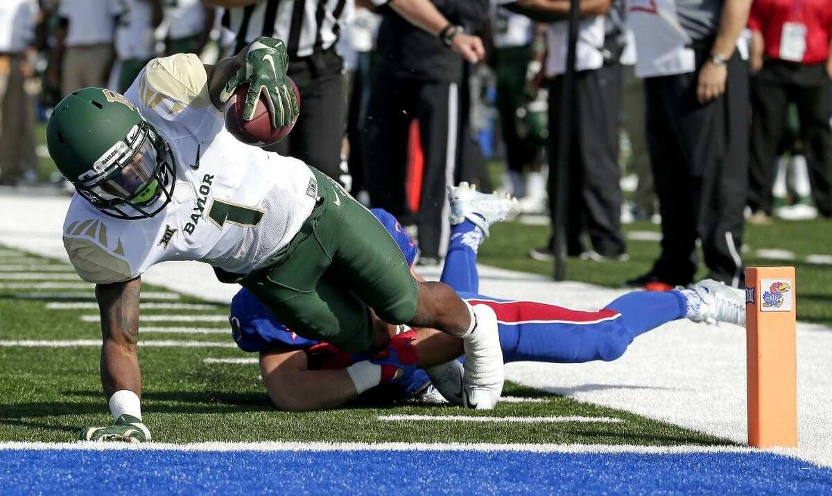 Baylor wide receiver Corey Coleman (1) dives into the end zone for a touchdown first half Saturday in Lawrence, Kan.