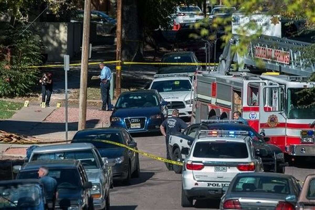 Police investigate the scene after a shooting Saturday, in Colorado Springs, Colo. Multiple are dead, including a suspected gunman, following a shooting spree according to authorities. Lt. Catherine Buckley said the crime scene covers several major downtown streets.