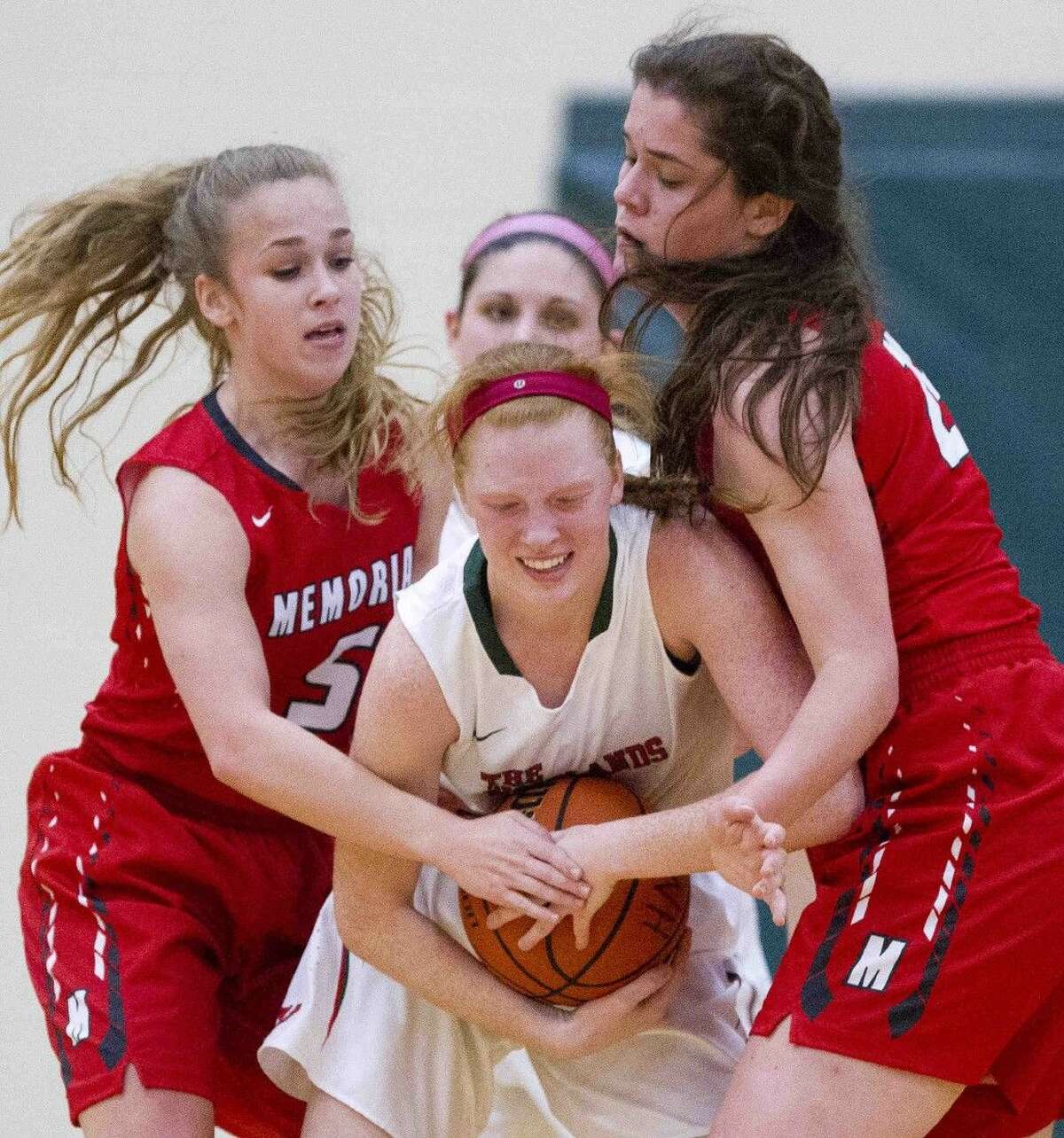 The Woodlands forward Madison Mcgurrin fights Memorial guard Kelsey Slattery and forward Elizabeth Eubank for control of a loose ball during a high school basketball game Tuesday, Nov. 24, 2015, in The Woodlands. Go to HCNpics.com to view more photos of the game.
