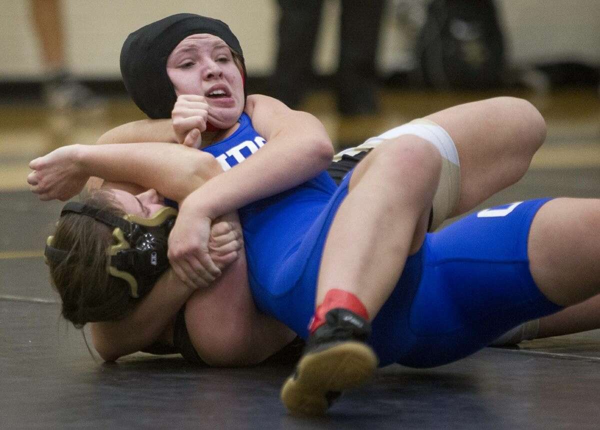 Oak Ridge’s Payton Klotzer works a headlock against Conroe’s Brooke McClellan in the girls 148-pound division in the Conroe Dual Invitational on Saturday. Klotzer won the match by a pin.