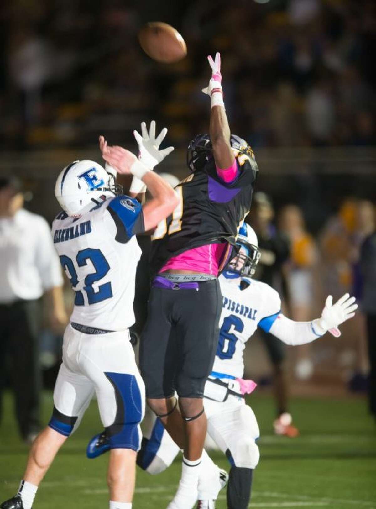 A Kinkaid receiver goes high in the air to pull in a pass with a pair of Episcopal defenders around him during the Falcons’ 20-10 Southwest Preparatory Conference South Zone victory over the Knights Friday evening at rainy Kinkaid School. The Falcons are now 8-0 on the season and will look to finish the regular season unbeaten Friday night when they play St. John’s at Rice Stadium.