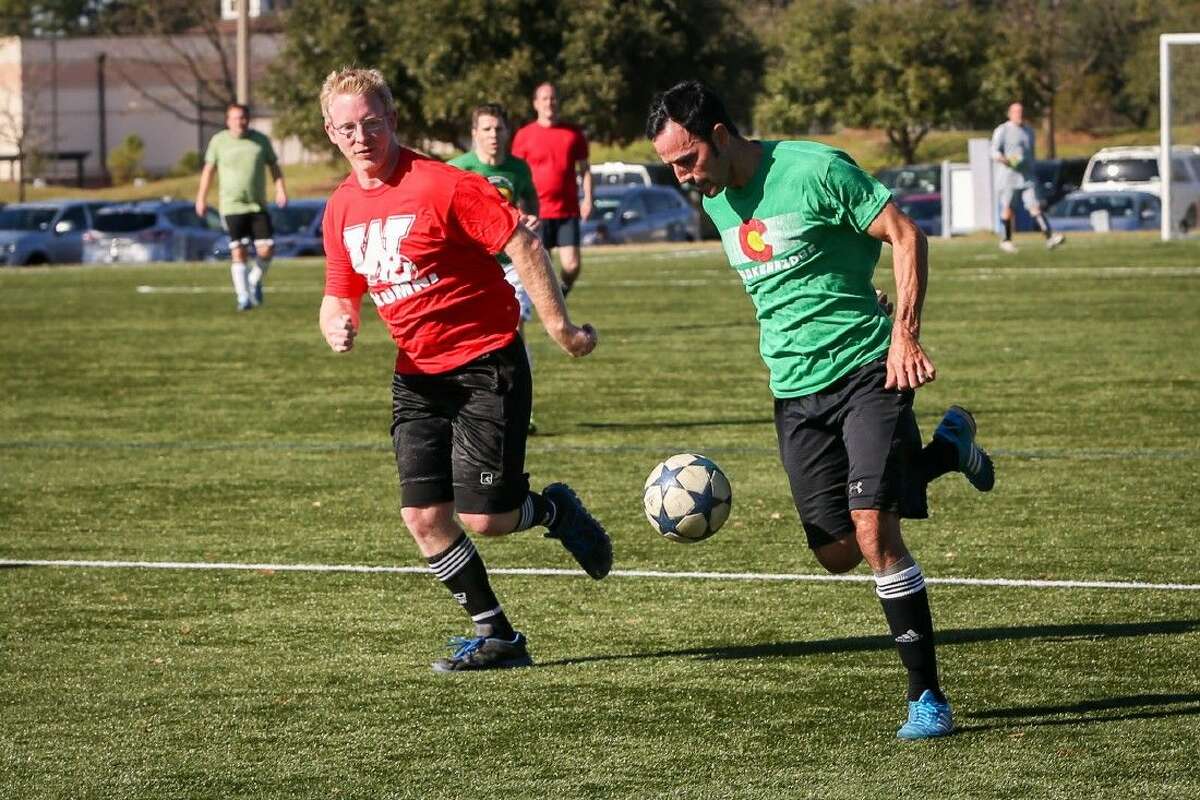 The Woodlands High School soccer team alumni, split into red and green teams, compete against one another on Saturday, Dec. 19, 2015, at Bear Branch Sportsfields.