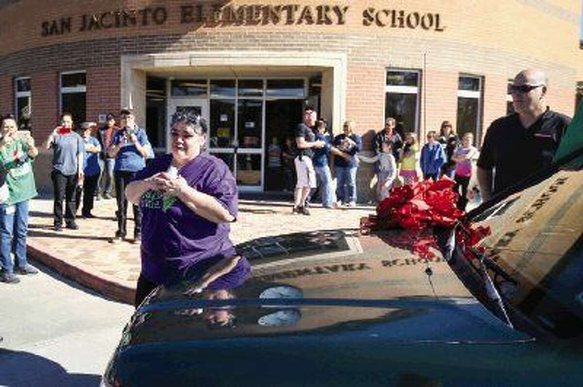 Cafeteria manager Betty Wilson reacts as coworkers, friends and family surprise her with a new car and funds they had raised on Friday at San Jacinto Elementary School.