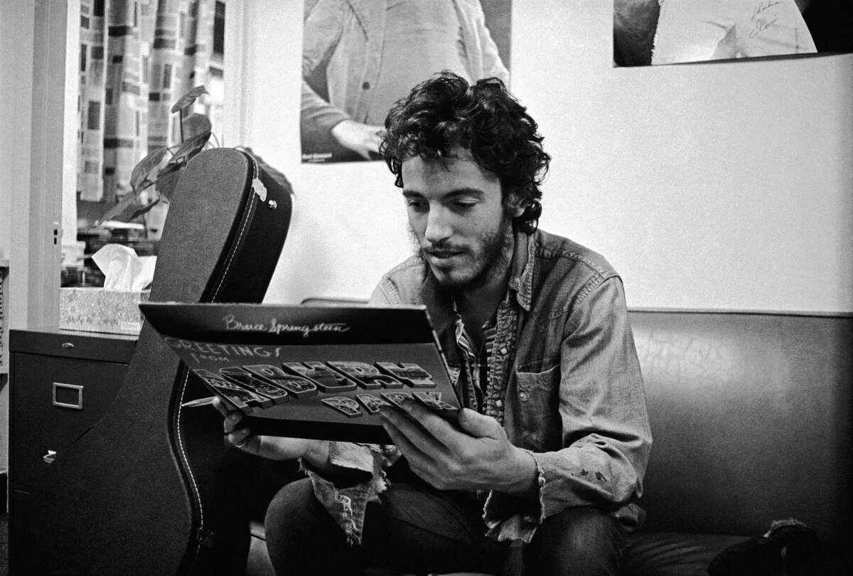 Bruce Springsteen gets his first look at a finished copy of his debut record, "Greetings from Asbury Park, N.J.," in 1973. Springsteen candidly writes about his successes and troubles in his memoir, "Born to Run."