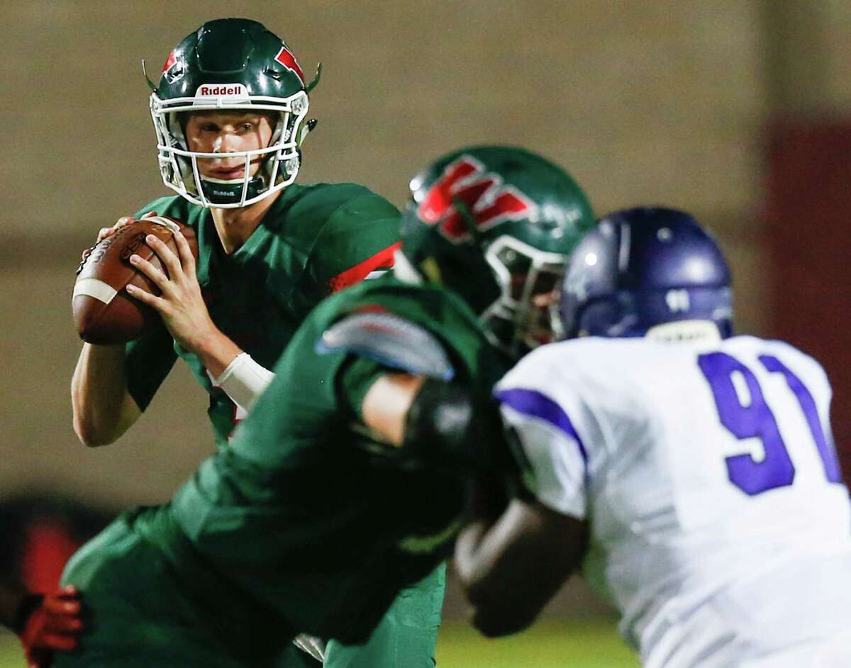 The Woodlands quarterback Eric Schmid (3) drops back to pass while being rushed by Lufkin defensive lineman Keith Overshine (91) during the fourth quarter of a District 12-6A football game at Woodforest Bank Stadium on Friday, Sept. 30, 2016, in Houston.