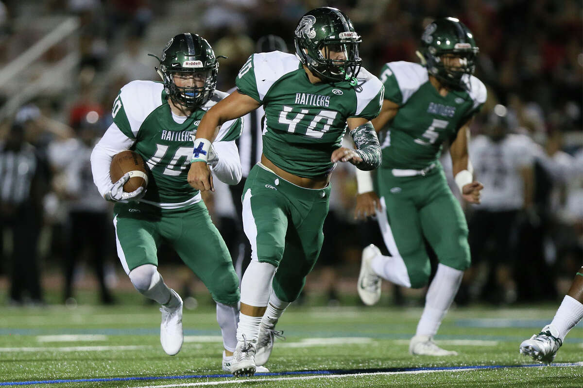 Reagan’s Spencer Gilliam (from left) follows his blockers, Leighton Dimando (40) and Lucas Eatman (5), after intercepting a pass during the first half of a District 26-6A game with Churchill at Comalander Stadium on Sept. 30, 2016.