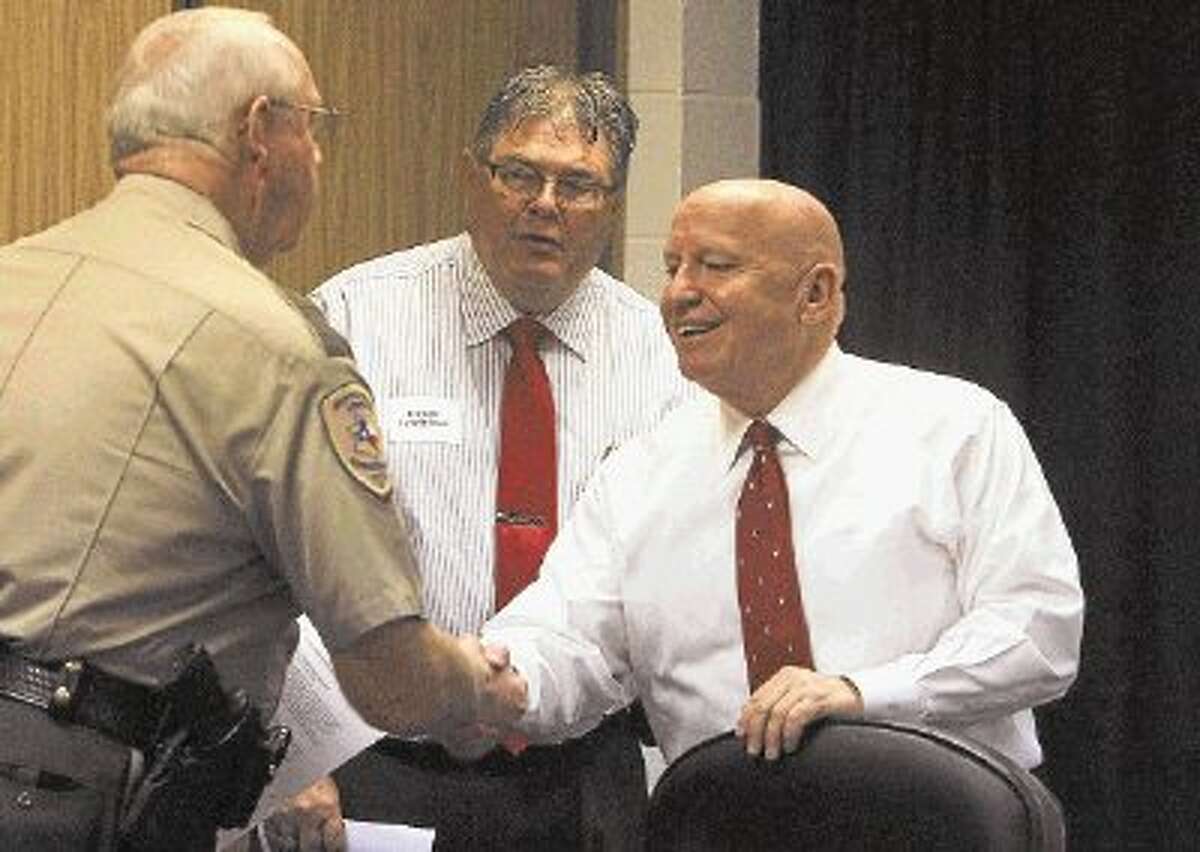 U.S. Rep. Kevin Brady, R-The Woodlands, shakes hands with Precinct 2 Constable Chief Deputy Steve Roper, left, and Precinct 2 Constable Gene DeForest, middle, at a roundtable Thursday at the Montgomery County Sheriff’s Office.