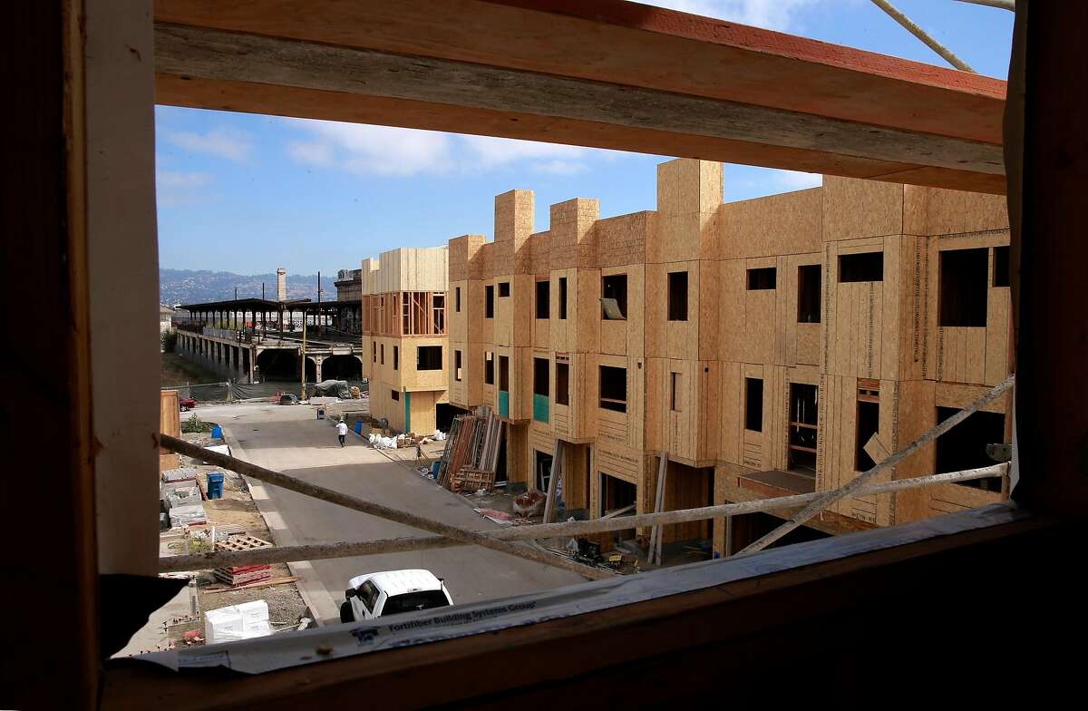 The landmark 16th street train station, (background) sits at the eastern border of the Station House development where homes are priced starting at $600,000 in West Oakland, California as seen on Thurs. Sept. 29, 2016.