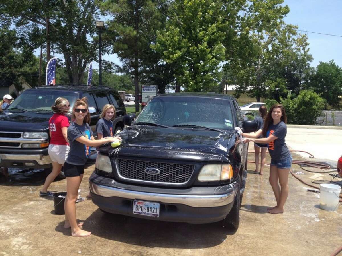 Dawson High Cheerleaders clean up at booster club carwash