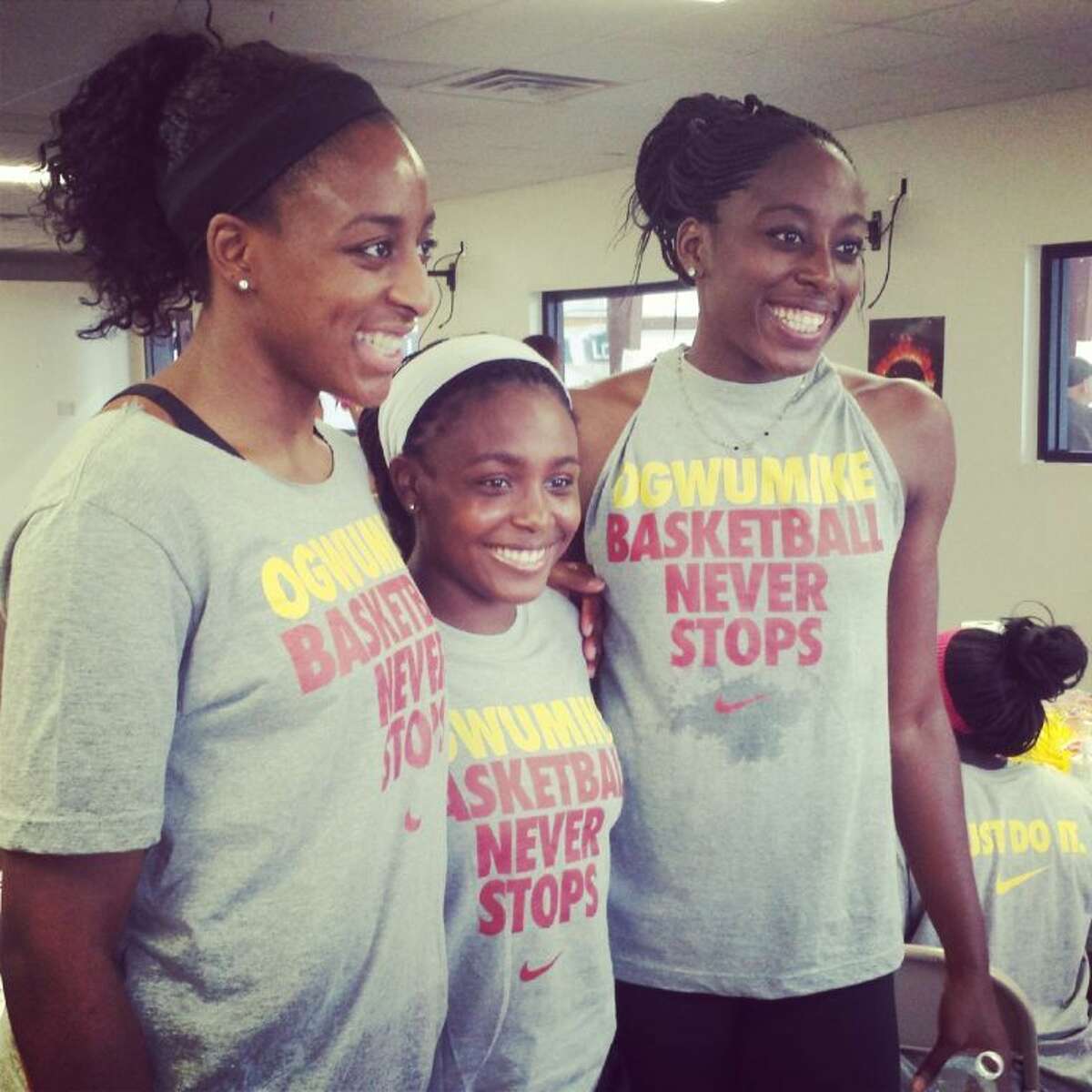 Nneka (left) and Chiney (right) pose for pictures at a basketball camp in September. The family continues to be involved in giving back to the Cypress community.
