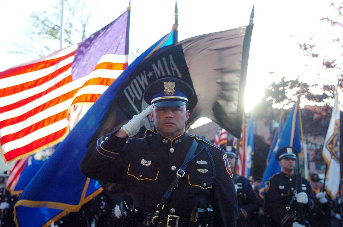 Stamford police parade turns streets blue and red