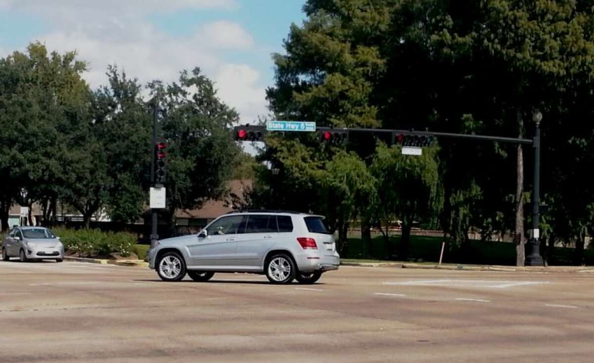A driver - who should receive a $75 notice of violation shortly - blows through a red light while turning left onto Highway 6 from Lexington Boulevard.