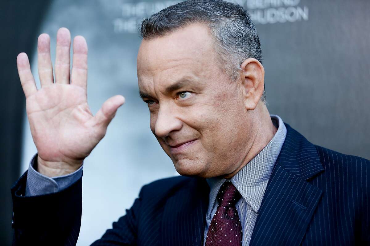 FILE - In this Sept. 8, 2016, file photo, Tom Hanks arrives at the LA Premiere of "Sully" at The Directors Guild of America Theater in Los Angeles. Hanks stopped to crash the wedding day photo shoot of a couple in New York's Central Park over the weekend. He posted a selfie he took with the bride and groom on Instagram Sunday, Sept. 25, 2016. (Photo by Rich Fury/Invision/AP, File)