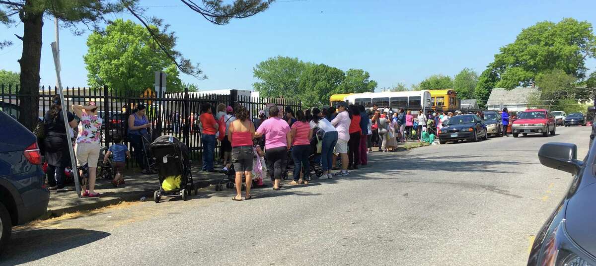 People wait in line for fresh produce from the CT Food Bank's Mobile food pantry in Stamford, Conn. A $46,000 grant given by the Untied Way of Western Connecticut will help pay for the program.