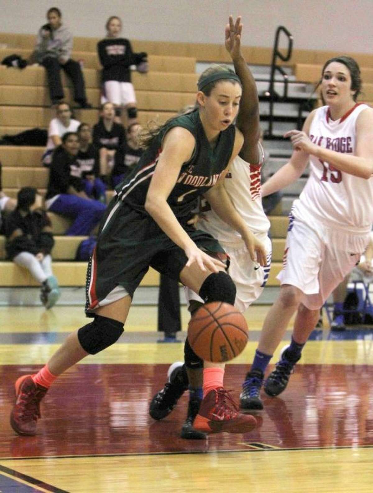 The Woodlands forward Nicole Iademarco dribbles in the paint during a District 14-5A game against Oak Ridge on Friday at Oak Ridge High School. The Lady Highlanders won, 67-35. To view or purchase this photo and others like it, visit HCNpics.com.