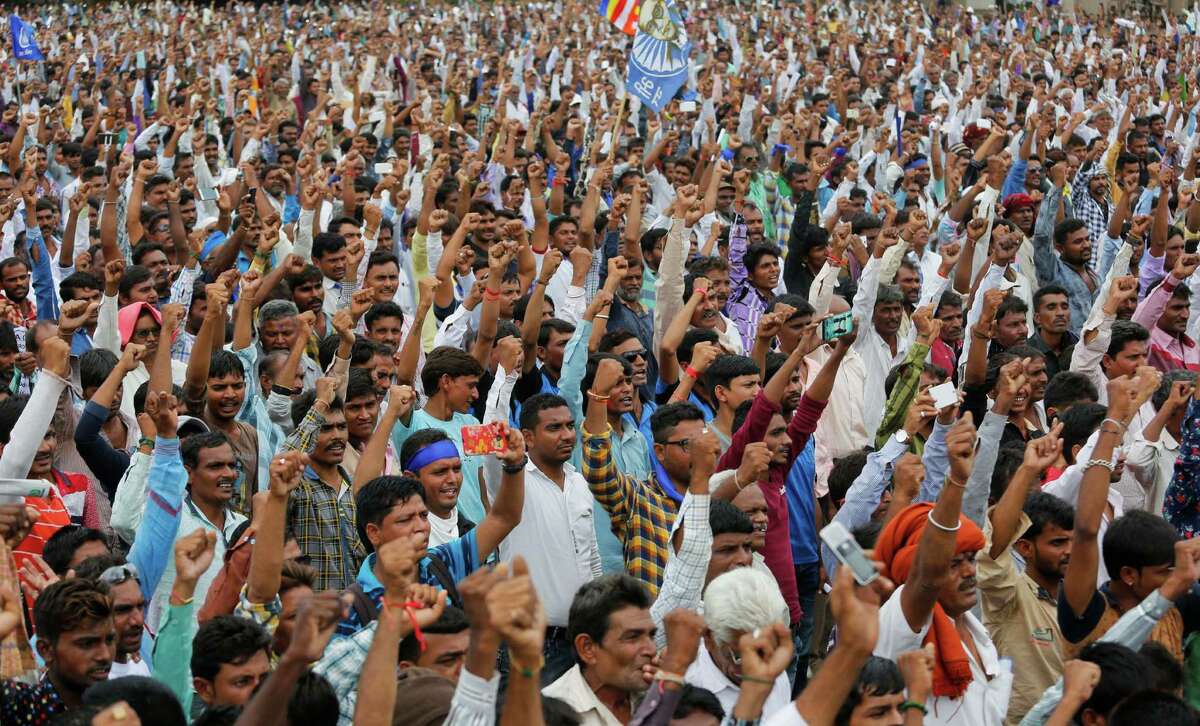 FILE- In this Aug. 15, 2016 file photo, hundreds of members of India's low-caste Dalit community gather for a rally in Una, Gujarat state, India as they protest after four men belonging to the Dalit community were beaten while trying to skin a dead cow in western India. The brutal beating of four men from the lowest rung of India's caste hierarchy, attacked for skinning a dead cow, has highlighted the persisting power of caste, 65 years after caste prejudice was banned in India. Dalits _ as "untouchables" are now called _ are increasingly signaling that they will no longer tolerate such bigotry, with an emerging class of educated and empowered young Dalits refusing to be cowed by the centuries-old discrimination, triggering deadly violence. (AP Photo/Ajit Solanki, File)