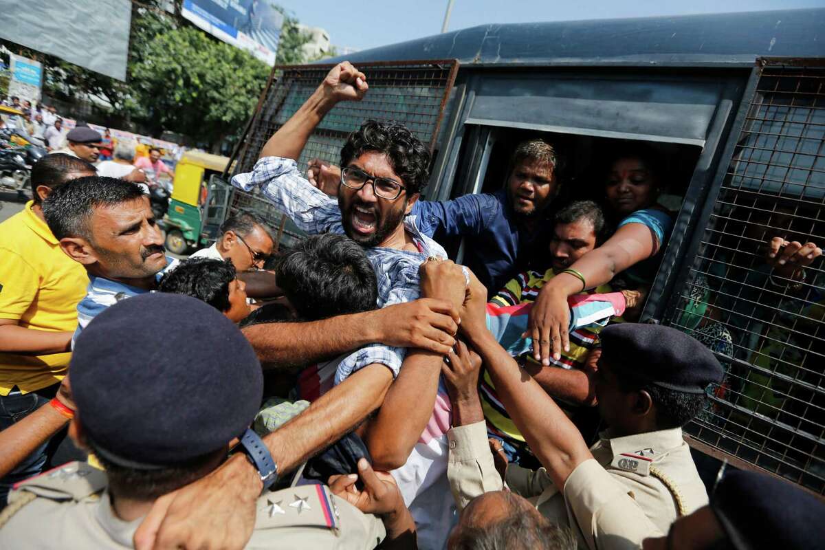 Policemen detain Dalit leader Jignesh Mevani during a protest by sanitation workers in Ahmadabad, India, Tuesday, Sept. 27, 2016. Mevani, a leader of the lowest rung of IndiaÂ?’s caste hierarchy, joined a protest demanding permanent jobs for sanitation workers who had been employed on contract basis for several years in the Ahmadabad Municipal Corporation. (AP Photo/Ajit Solanki)