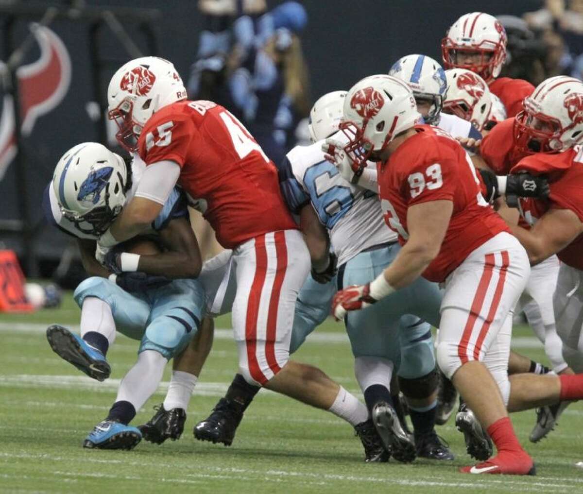 Katy's Jake Blomstrom stops Johnson's Braedon Williams during State Semifinals game at Reliant Stadium in Houston on Saturday, Decemeber 14, 2013. Katy won the game 52-0.