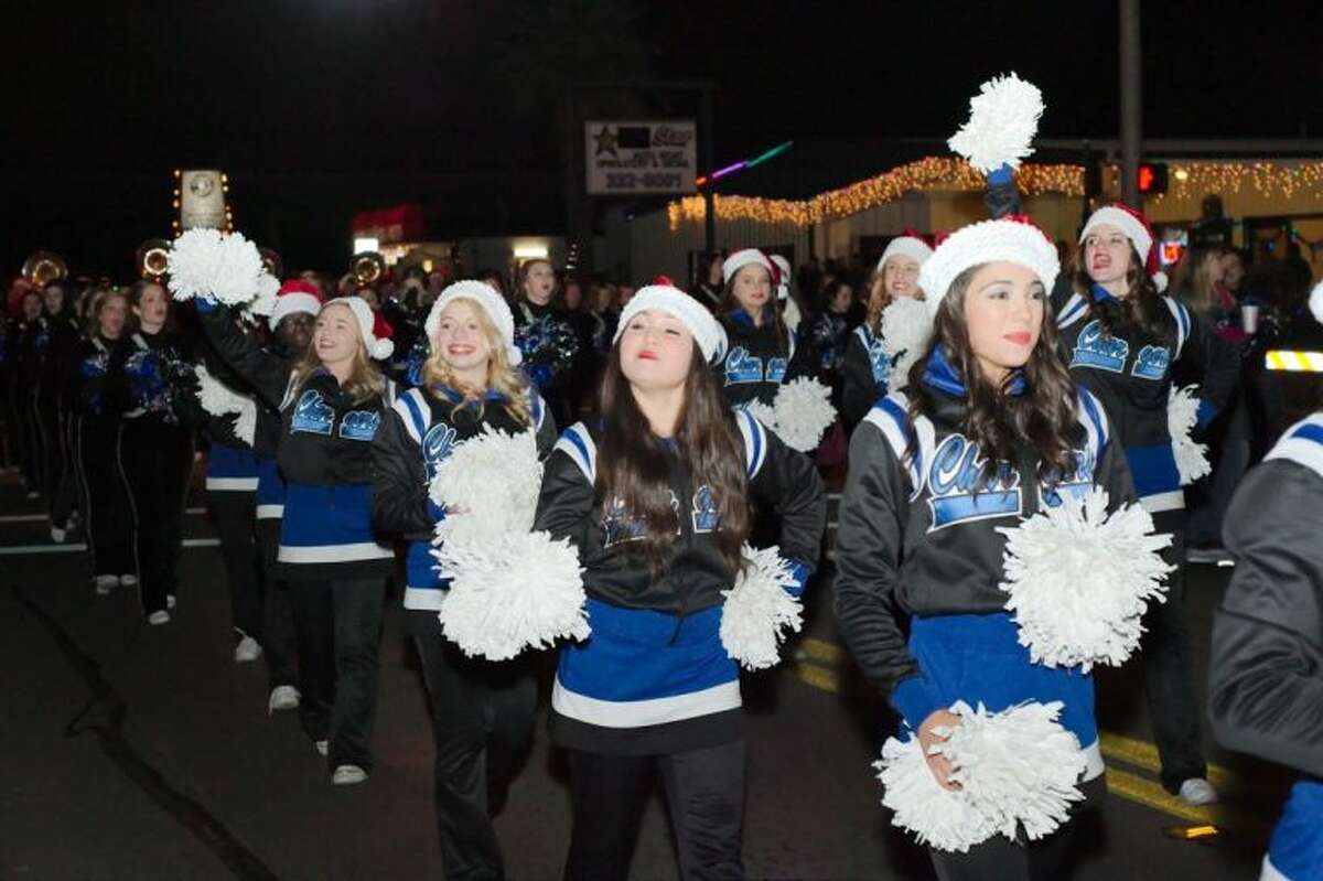 The Clear Springs cheerleaders march down Main Street in the annual League City Holiday in the Park Grand Night Parade Saturday.