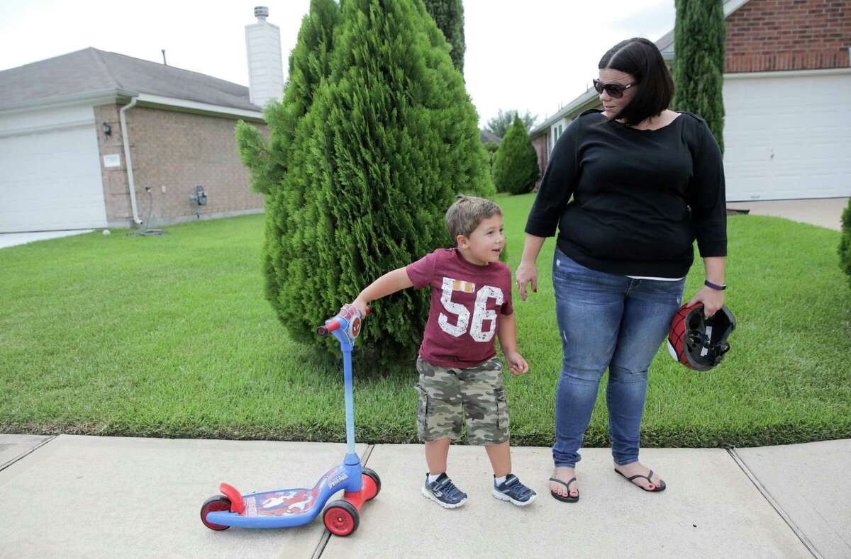 Lezlie Walla hangs out with her son, Caleb, 4, Thursday, Sept. 15, 2016, in Houston. Even though she has insurance, Walla has had to put off taking her kids to the doctors because of her deductible. ( Elizabeth Conley / Houston Chronicle )