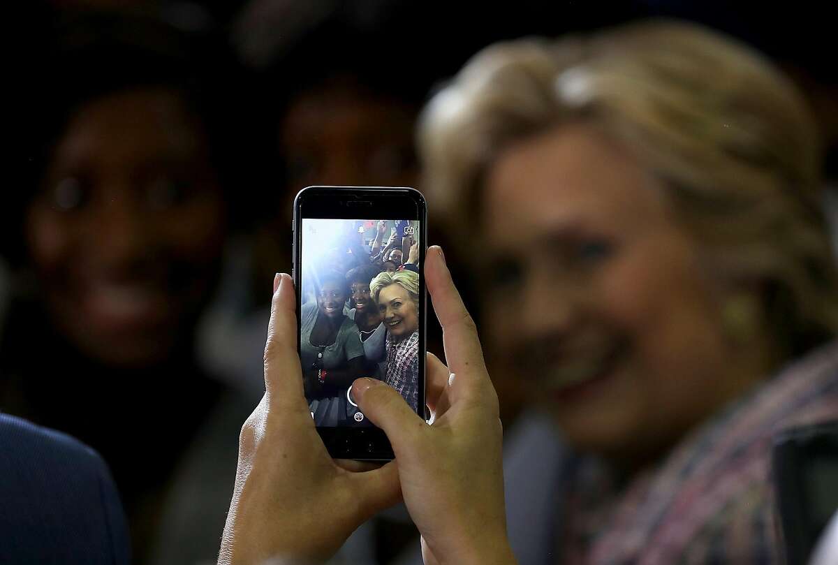 CORAL SPRINGS, FL - SEPTEMBER 30: Democratic presidential nominee former Secretary of State Hillary Clinton takes a selfie with a supporter during a campaign rally at Coral Springs Gymnasium on September 30, 2016 in Coral Springs, Florida. Hillary Clinton is campaigning in Florida. (Photo by Justin Sullivan/Getty Images)