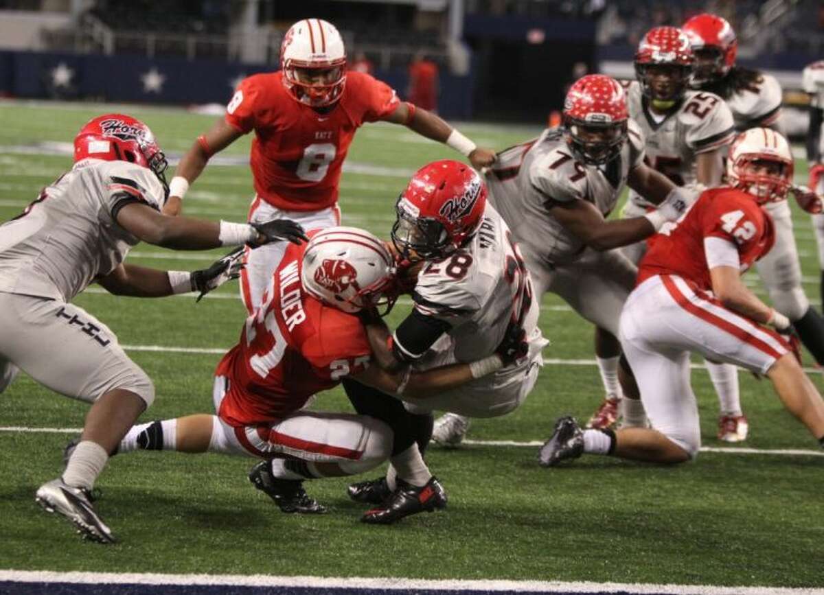 Katy's Collin Wilder tries to stop Cedar Hill's Aca'Cedric Ware from scoring the game-clinching touchdown during the Class 5A Division II Football State Championship game Dec. 21 at AT&T Stadium in Arlington. Cedar Hill won 34-24.
