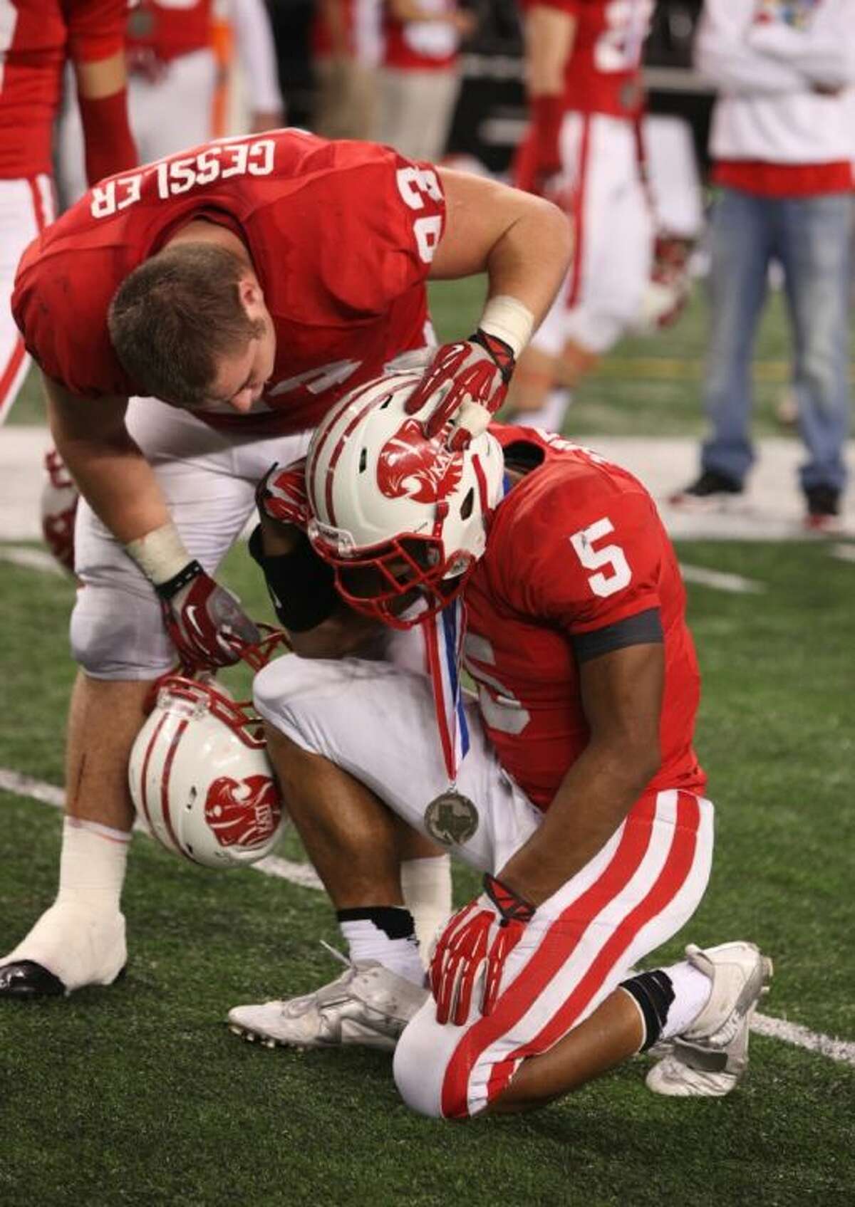 Katy's Cody Gessler consoles Kyle Porter after the Tigers' 34-24 defeat against Cedar Hill.