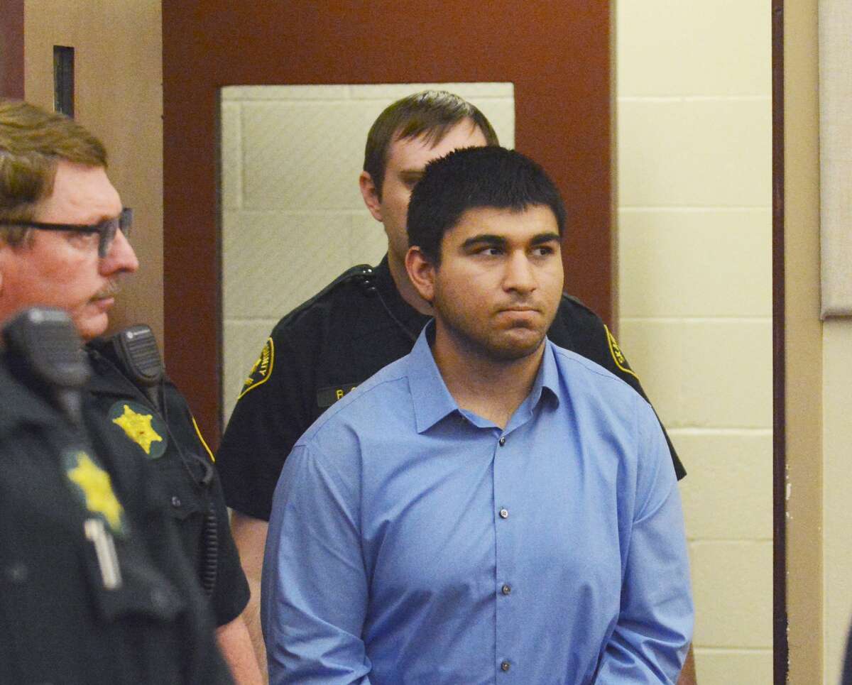 FILE - In this Monday, Sept. 26, 2016 file photo, Arcan Cetin is escorted into Skagit County District Court by Skagit County's Sheriff's Deputies, in Wash. Detectives are investigating a tip that the suspect in a deadly mall shooting north of Seattle may have tried unsuccessfully to purchase a handgun just hours before the slayings occurred. Authorities say Cetin used a .22-caliber Ruger rifle when he opened fire Friday, Sept. 23, at the Cascade Mall in Burlington, Wash., killing five. (Brandy Shreve/Skagit Valley Herald via AP, File)