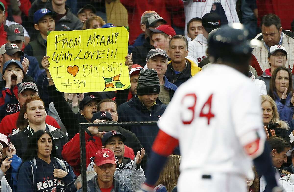 A fan holds a sign as Boston Red Sox's David Ortiz comes to bat during the seventh inning of a baseball game against the Toronto Blue Jays in Boston, Sunday, Oct. 2, 2016. (AP Photo/Michael Dwyer)