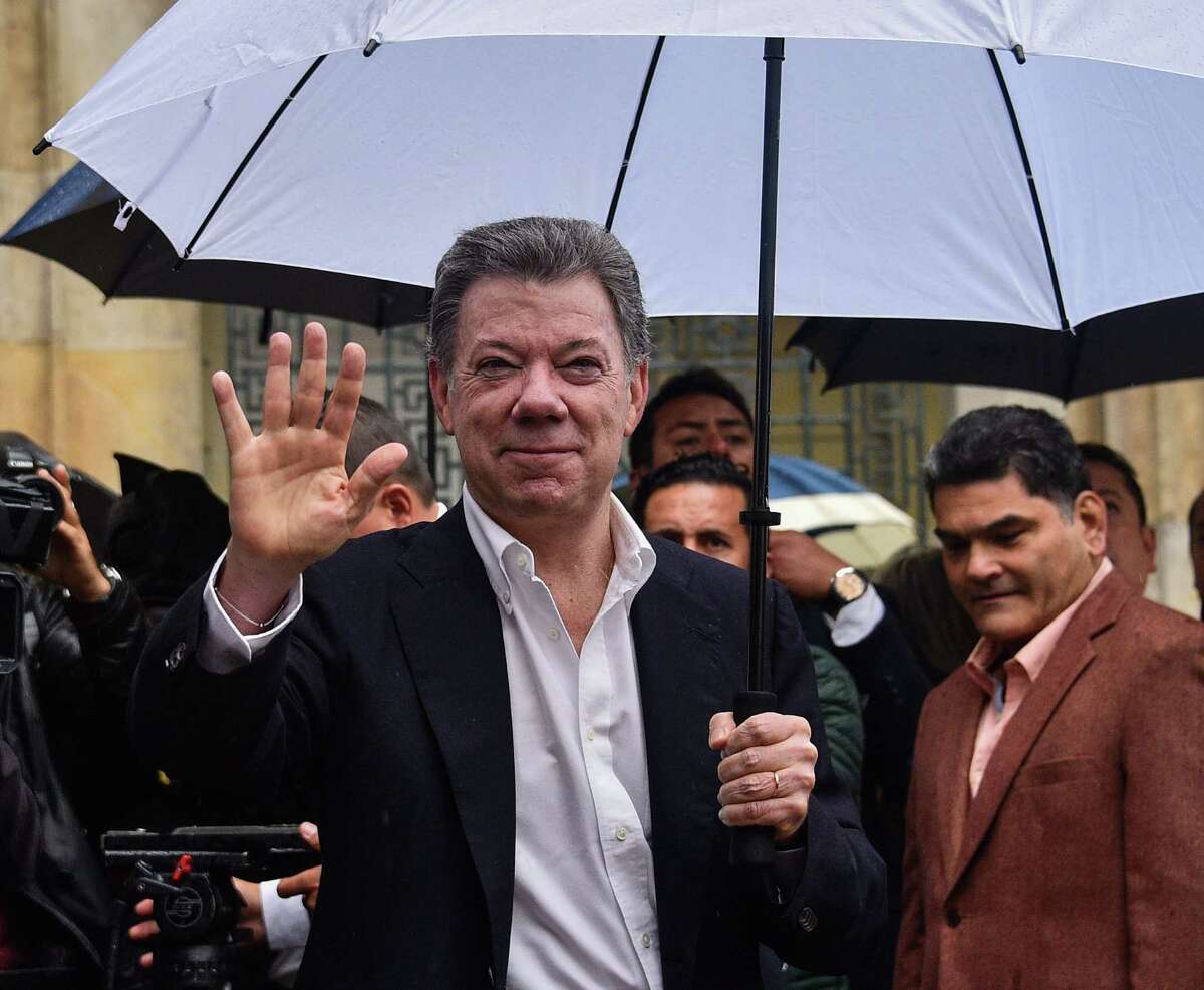 Colombian President Juan Manuel Santos waves after casting his vote during a referendum on whether to ratify a historic peace accord to end a 52-year war between the state and the communist FARC rebels, in Bogota on October 2, 2016. The accord will effectively end what is seen as the last major armed conflict in the Western Hemisphere. The war has killed hundreds of thousands of people and displaced millions. / AFP PHOTO / GUILLERMO LEGARIAGUILLERMO LEGARIA/AFP/Getty Images