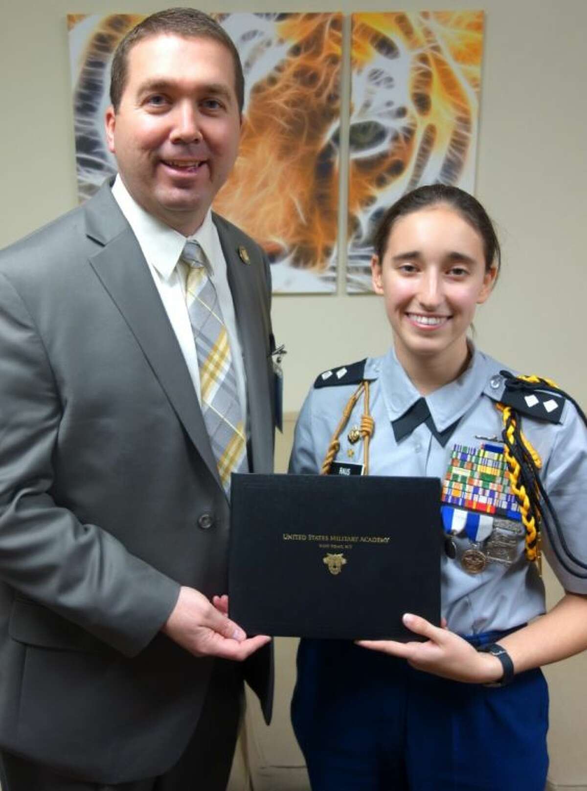 Conroe High School Principal Dr. Mark Weatherly congratulates senior Tala Raus on her acceptance into West Point Academy.