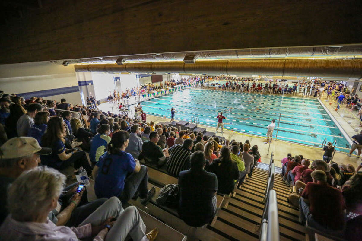 Spectators watch as swimmers compete in the CFISD district tournament on Saturday, Feb. 1, 2014, at Cy Ranch High School. (Michael Minasi / HCN)