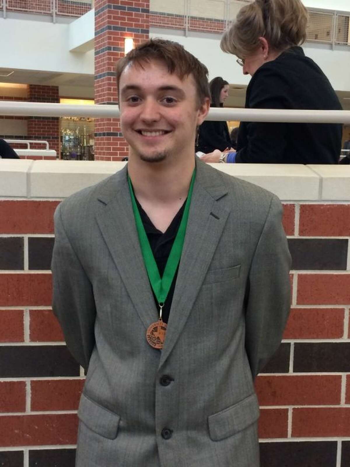 Cleveland High School student Timothy Burleson shows off his sixth-place medal for Prose Interpretation from the Livingston Invitational UIL meet on Feb. 8.