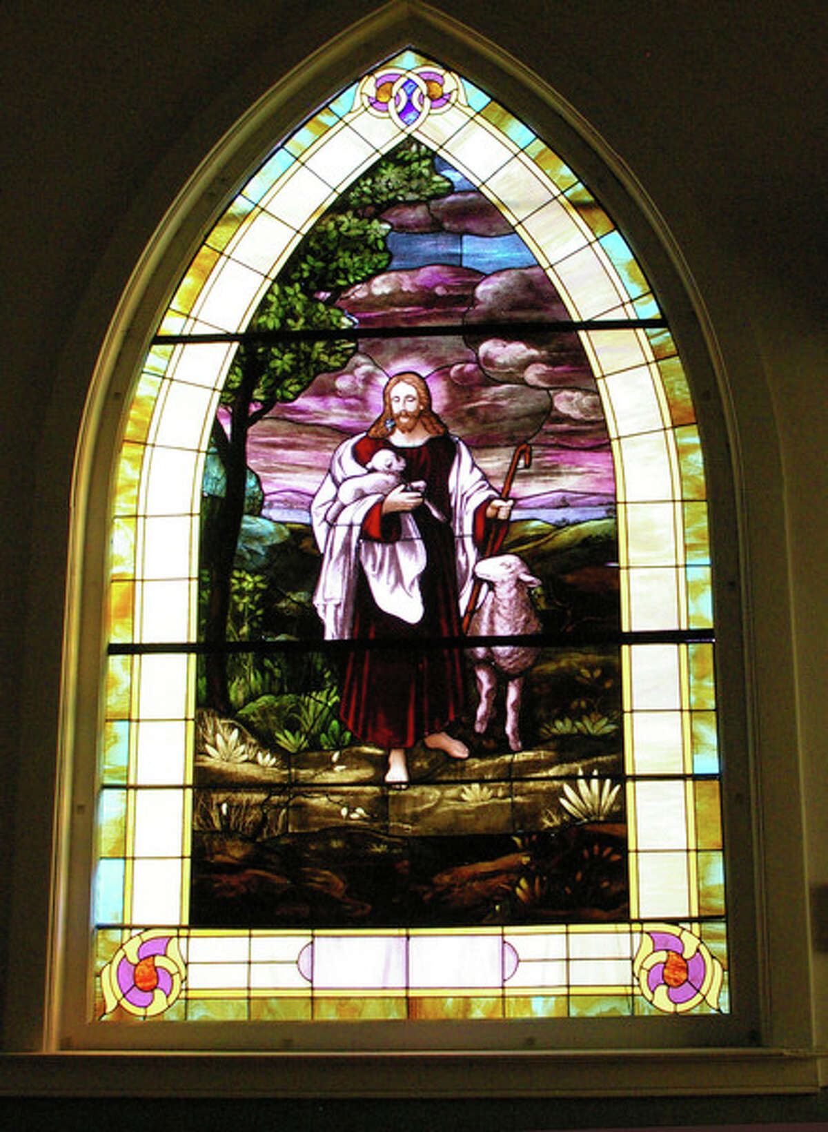 Inside the church, stained glass windows of various sizes filter the light.