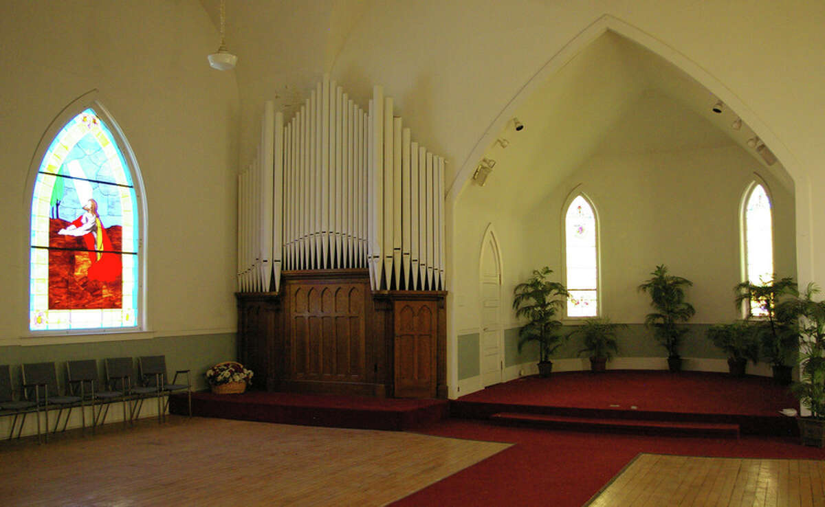 The inside of the church reveals classic architecture, stained glass windows and organ pipes.