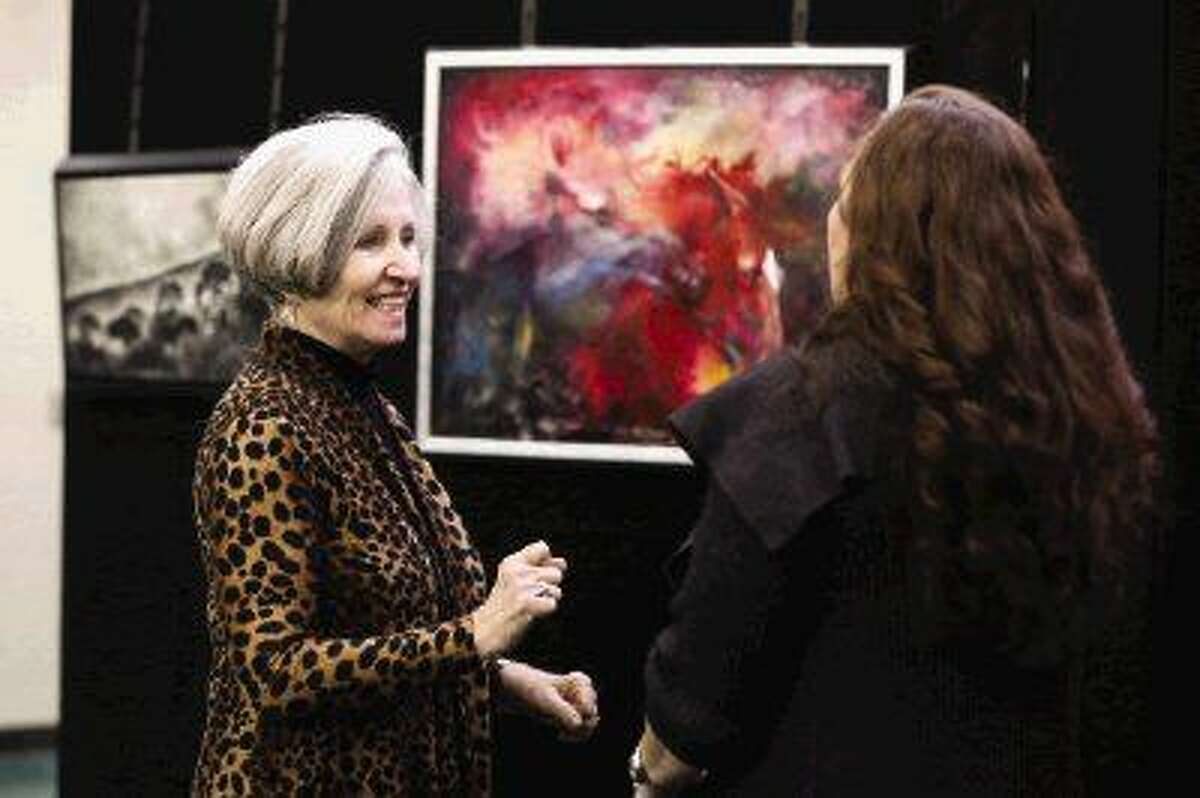 Anatomy and physiology teacher Martha Mitchell, left, speaks with Art Trust volunteer Carol Durkee during The 100 Friends of Art Luncheon on Friday at The Woodlands High School.