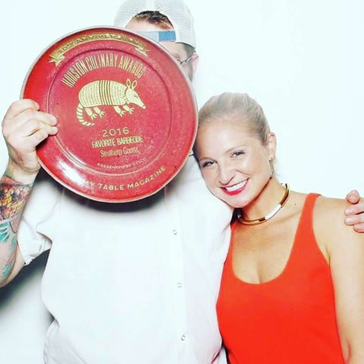 Chef Patrick Feges of Southern Goods, hiding behind his award for Favorite Barbecue at the Houston Culinary Awards, with his wife, Erin Smith Feges