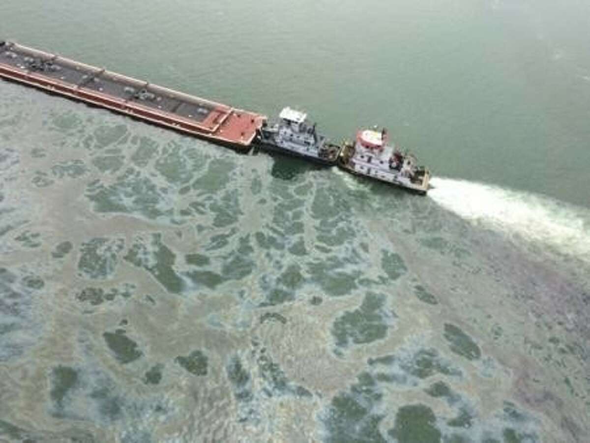 A barge loaded with marine fuel oil sits partially submerged in the Houston Ship Channel, March 22, 2014. The bulk carrier Summer Wind, reported a collision between the Summer Wind and a barge, containing 924,000 gallons of fuel oil, towed by the motor vessel Miss Susan.