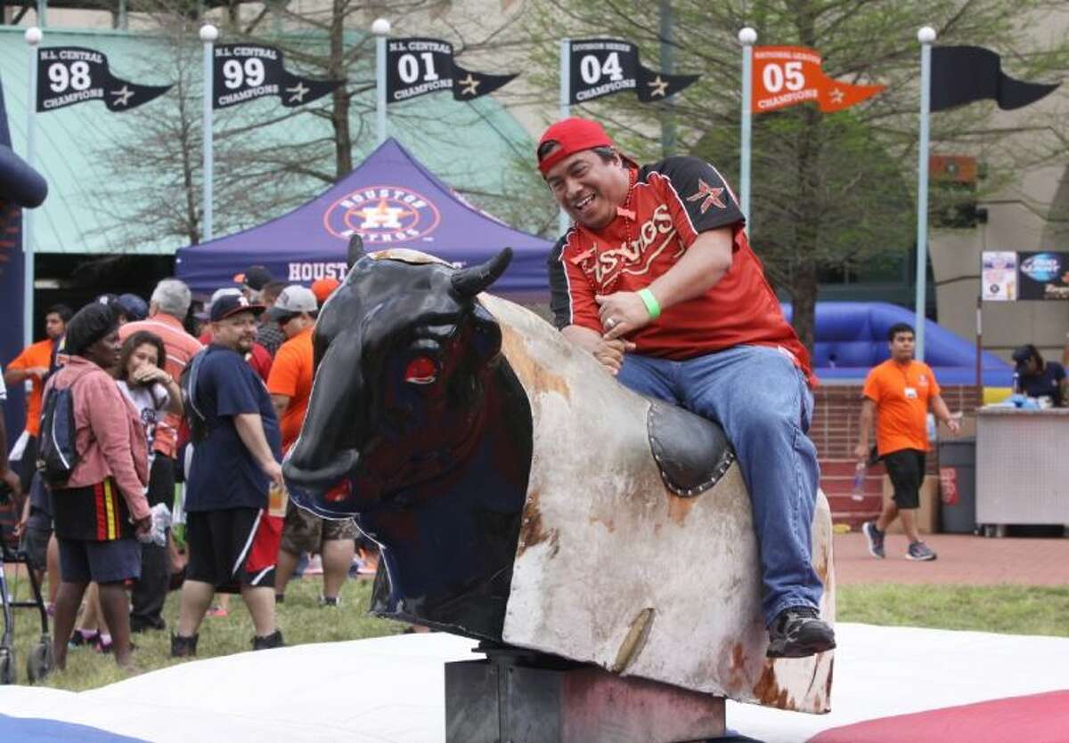 Bon Castaneda of Houston tries to hang on to a mechanical bull April 1 at the Opening Day Street Festival on Crawford Street outside of Minute Maid Park.